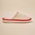 Side view of Essential Eden Rock slipper in beige with soft terry upper, red trim and Eden Roc embroidery on neutral backdrop