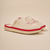 Three-quarter view of beige Essential Eden Rock slipper with terry upper, red Eden Roc embroidery, red trim and cream EVA sole