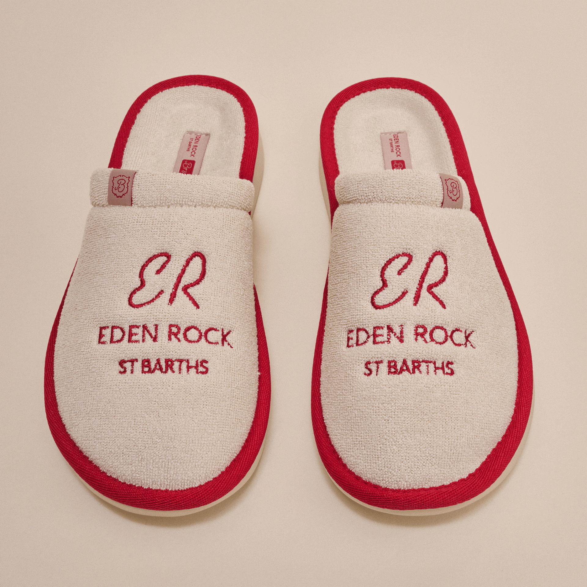 Overhead view of beige terry Eden Rock slippers with red trim showing red embroidered ER Eden Rock St Barths on top