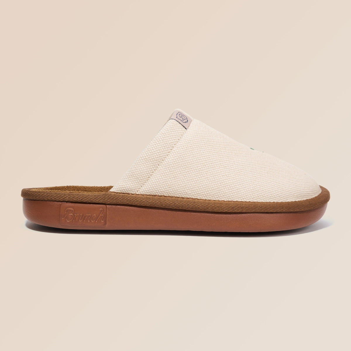 Side view of beige Essential Floral canvas slipper with sunflower embroidery and brown cushioned sole on neutral background