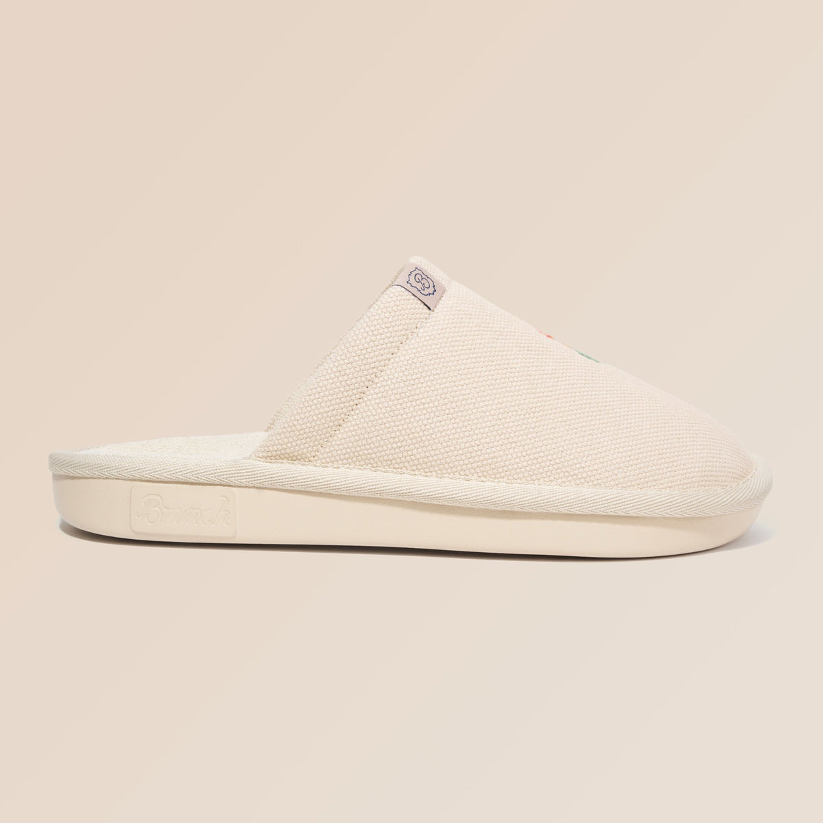 Side view of Essential Floral canvas slipper in beige Wildflower showcasing hand-stitched floral embroidery on a neutral beige background