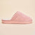 Side view of pink Hello Kitty terry slipper showing plush terry upper, embroidered Hello Kitty tag, and molded Brunch sole on a beige background