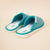 Three-quarter view of Essential Hirshleifers marine slippers showing teal-gray knit upper and cushioned white terry footbed