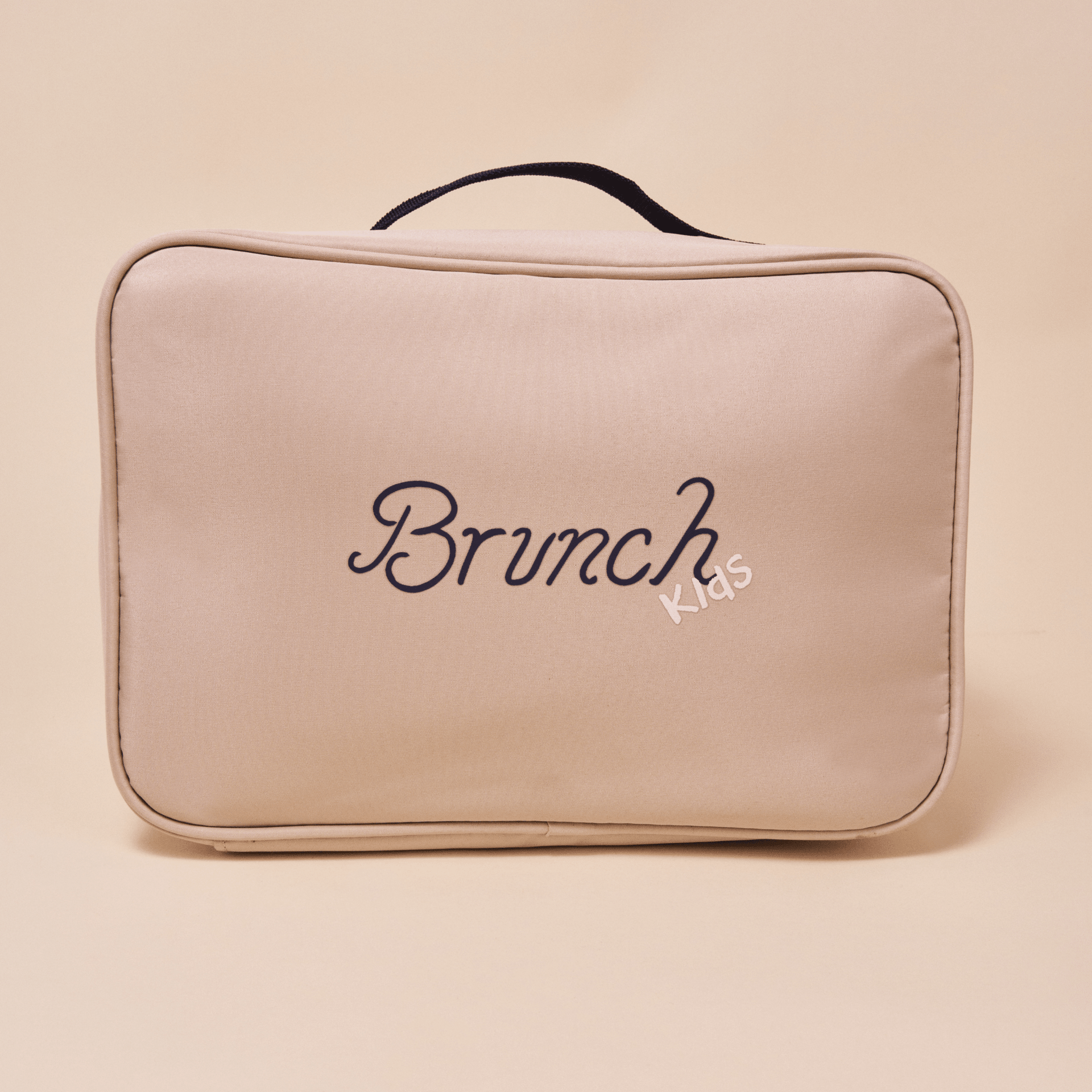 Front view of beige Brunch Kids pouch showcasing embroidered Brunch logo, small Kids script, and top handle on a beige background