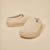 Front three-quarter view of Essential Kids slipper in beige terry showcasing terry knit upper and molded EVA outsole on a neutral background