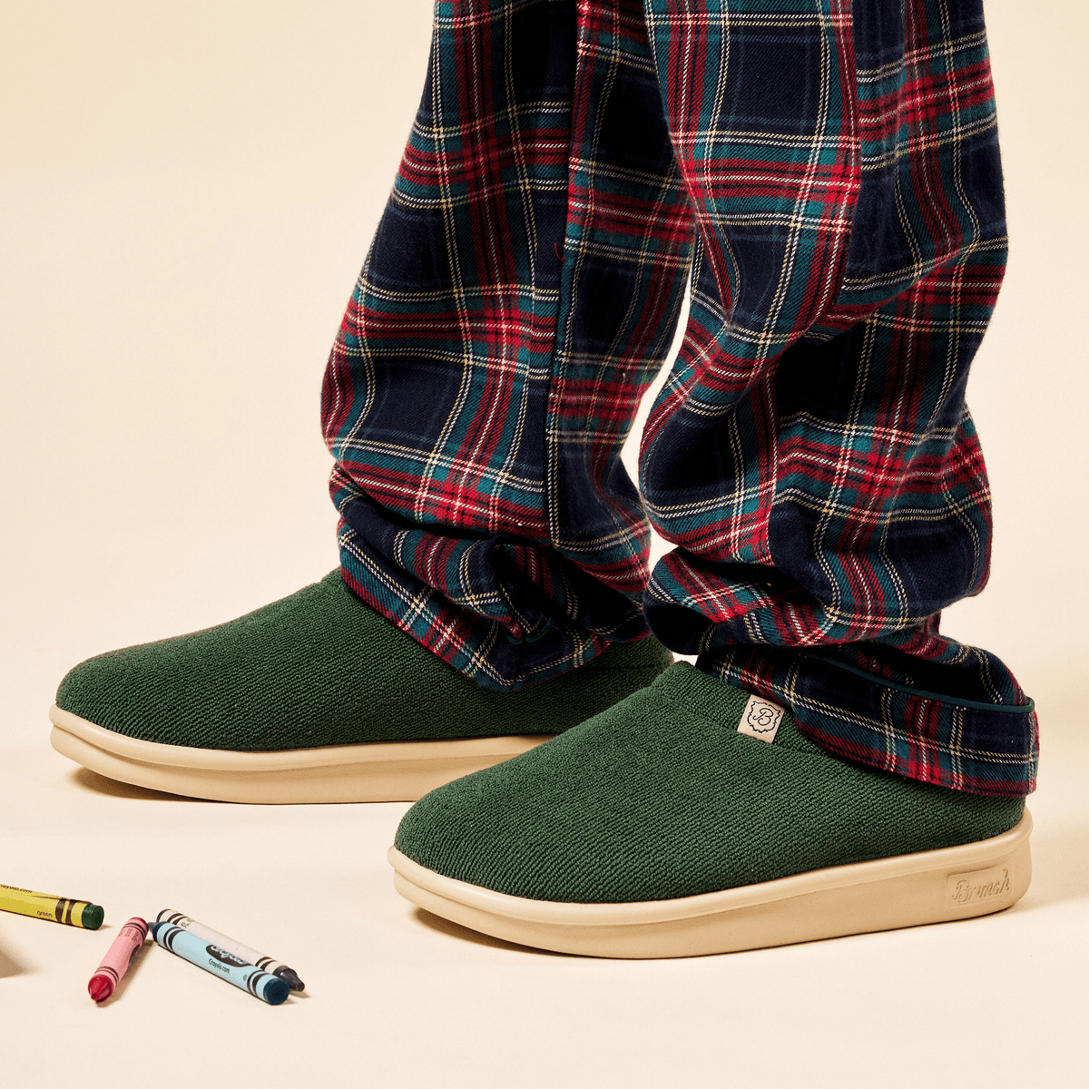 Three quarter view of Essential Kids slipper in emerald terry showing terry upper and cream EVA outsole on neutral background