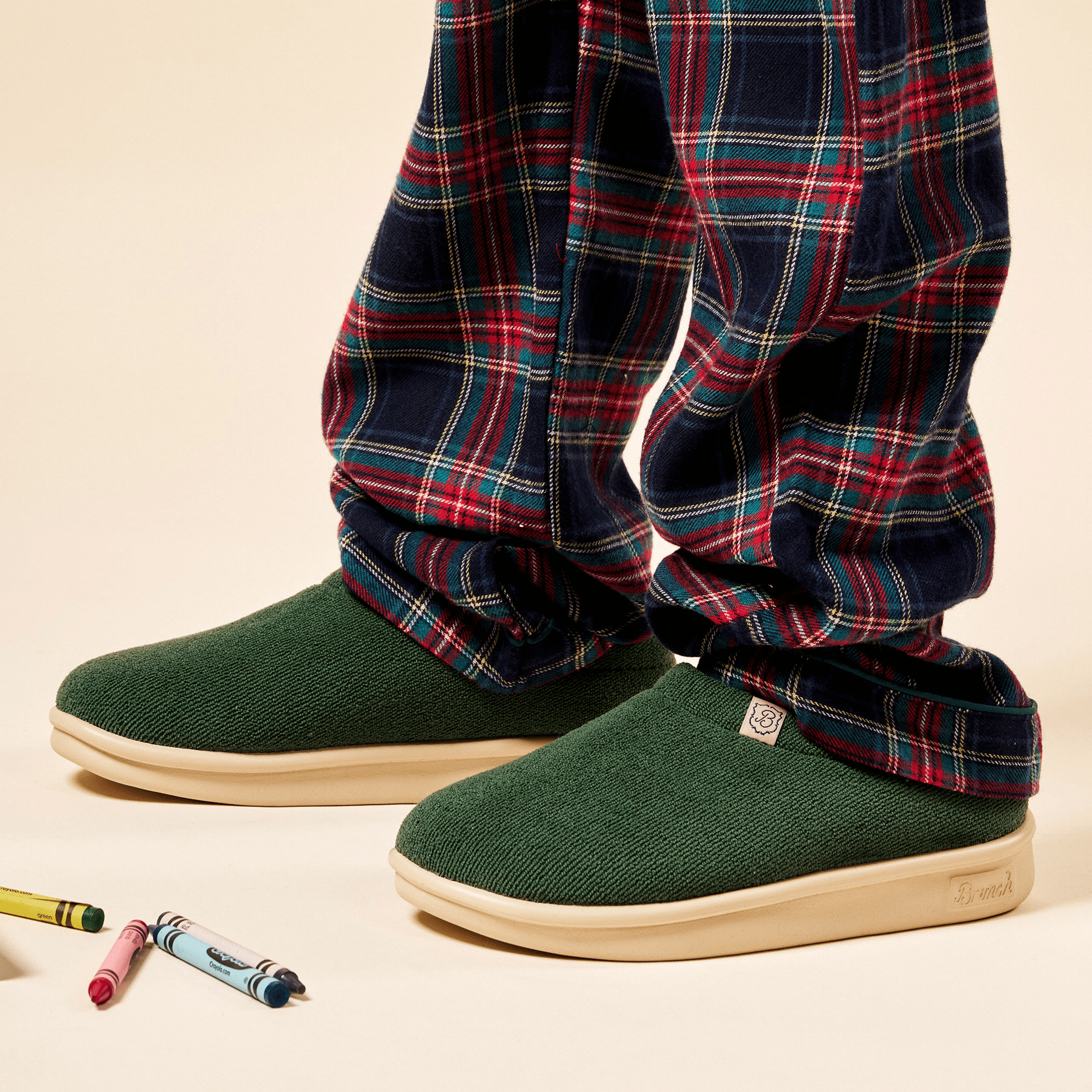 Three quarter view of Essential Kids slipper in emerald terry showing terry upper and cream EVA outsole on neutral background