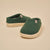 Front three-quarter view of Essential Kids slipper in emerald terry with cream EVA sole on beige background