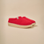 Three-quarter view of Essential Kids slipper in red terry showing plush upper and cream EVA outsole on beige background