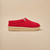 Side view of Essential Kids slipper in red terry showing textured terry upper and cream EVA outsole on beige background