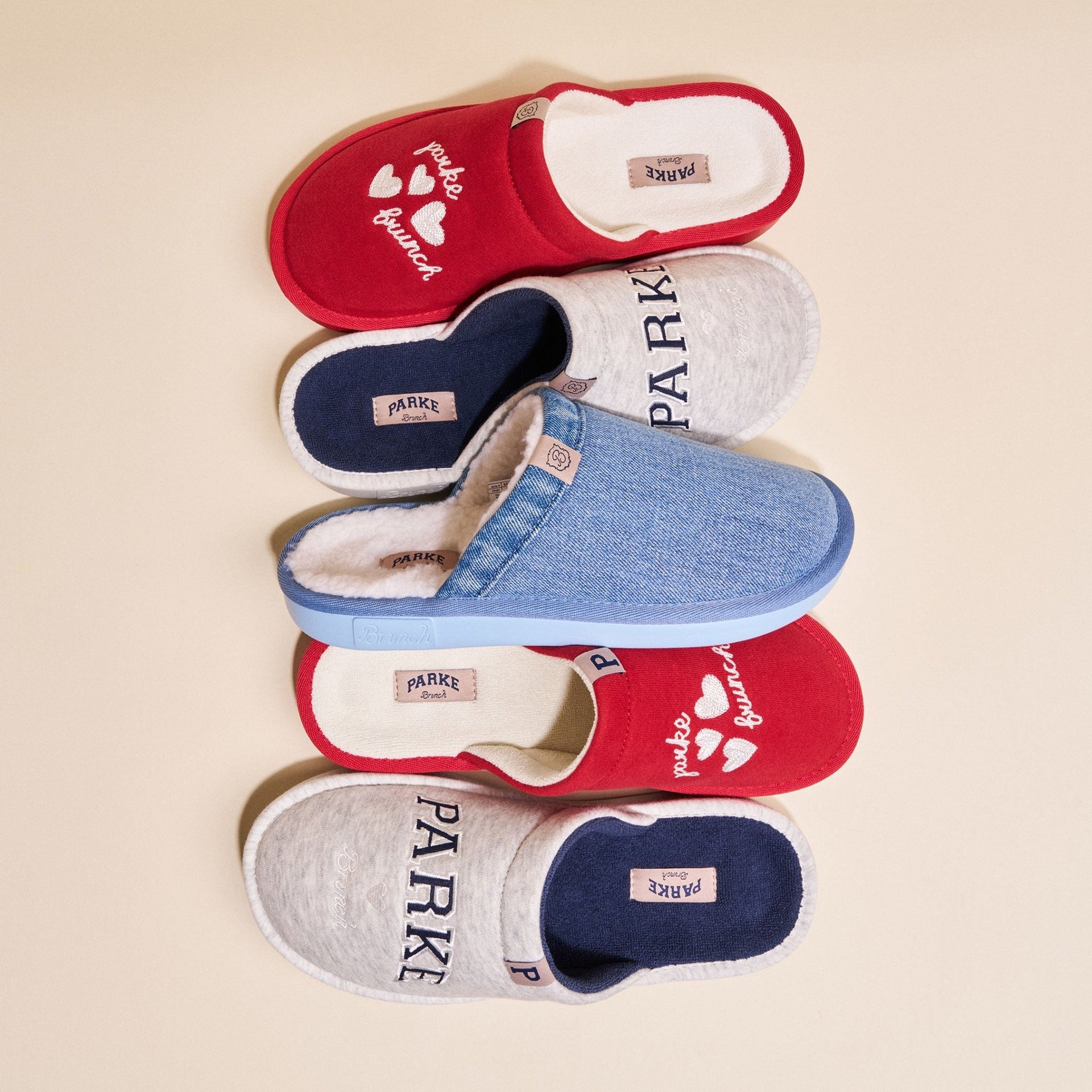 Top view of Vintage Denim Parke slipper showcasing washed denim upper and plush shearling lining on a pale beige background