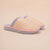 Three-quarter view of Cozyland Essential slip-on slipper with pastel rainbow stripes, pink trim and plush lining