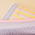 Close-up side view of Essential Rainbow slipper with pastel stripes, three Z accents, pink trim and lilac sole