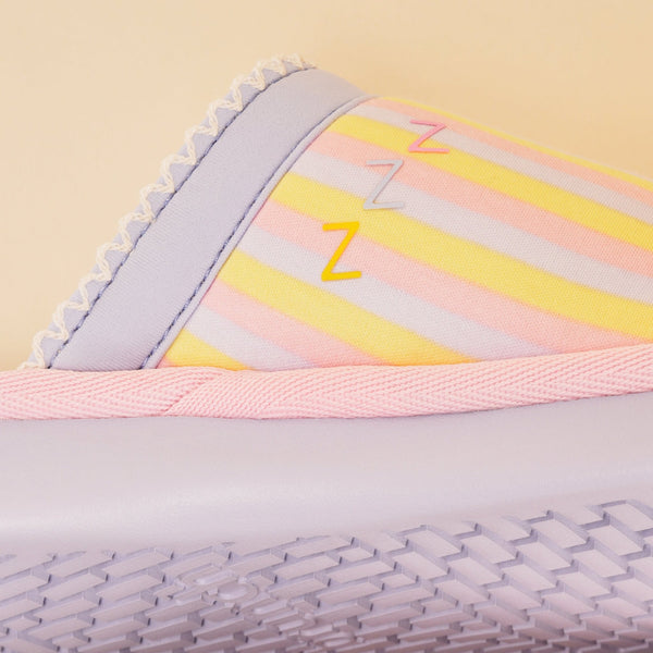 Close-up side view of Essential Rainbow slipper with pastel stripes, three Z accents, pink trim and lilac sole