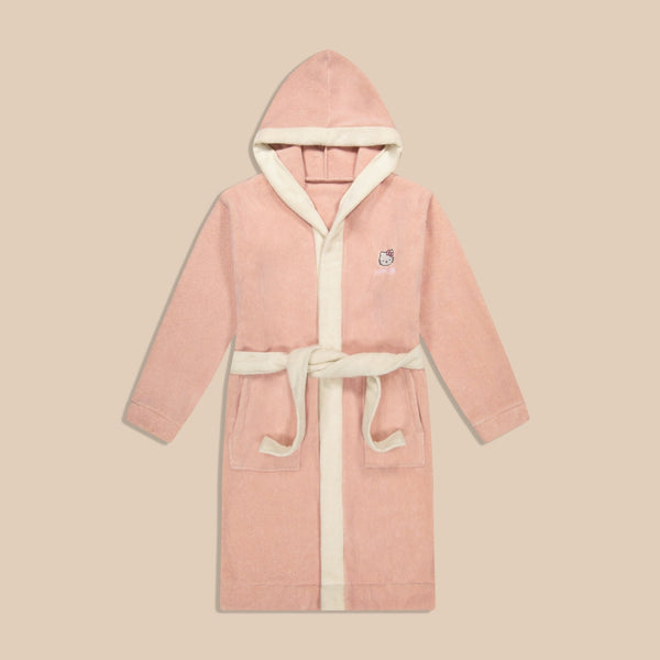 Front view of pink hooded robe with Hello Kitty embroidery, contrast cream trim, pockets, and belt on beige background