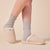 Side view of Essential Shearling suede slipper on model showing cream-beige suede upper, plush shearling lining, low-back slip-on