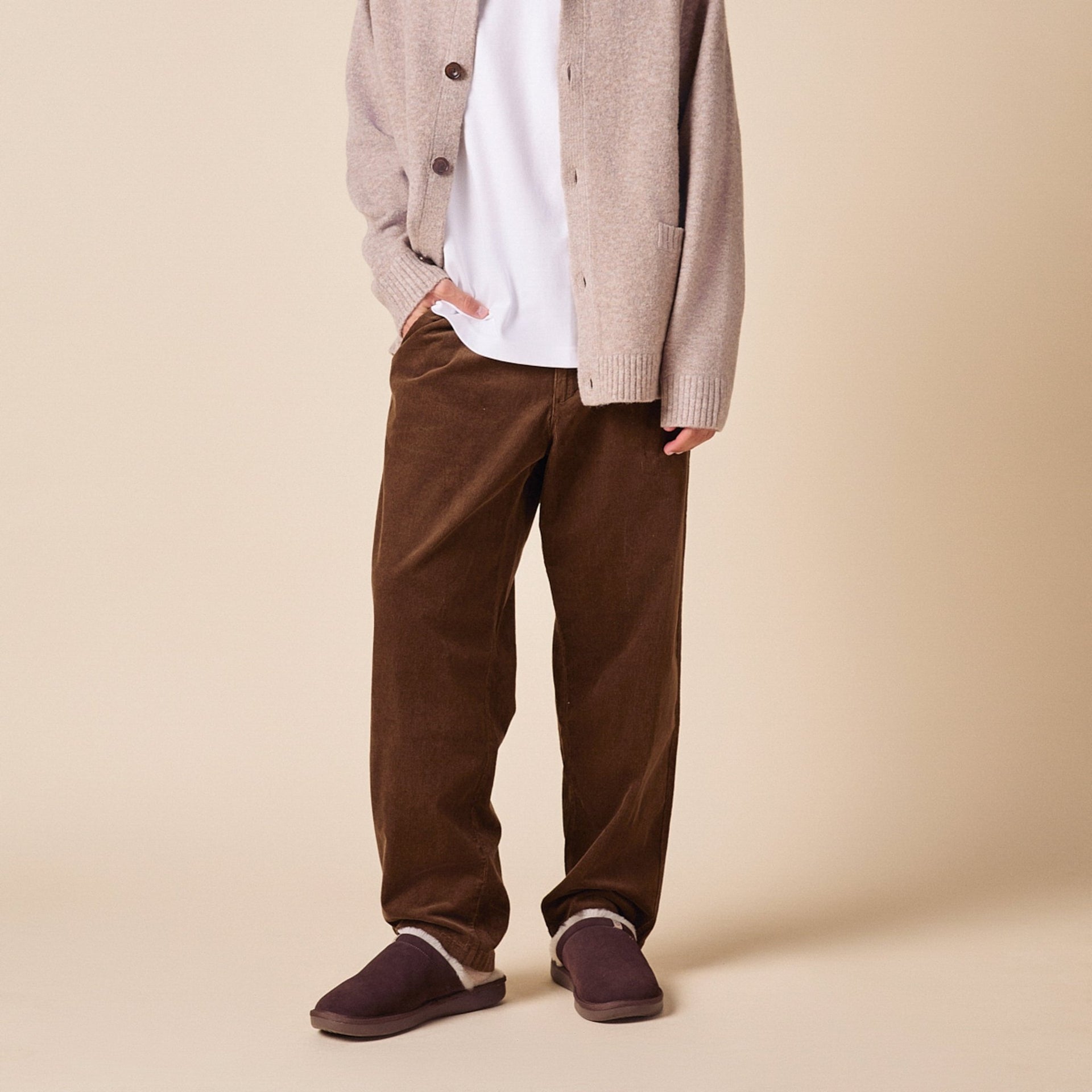 Front view of Essential Shearling suede slippers on model showing plush shearling lining and low profile sole on beige background
