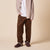 Front view of Essential Shearling suede slippers on model showing plush shearling lining and low profile sole on beige background
