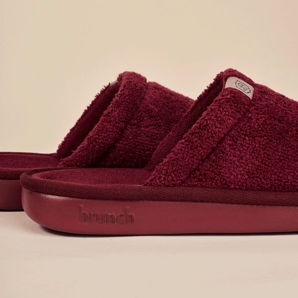 Close up side view of Essential slipper in burgundy showing terry loop upper and cushioned sole embossed brunch logo