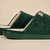 Side view of green Essential slipper with plush terry upper, cream footbed and embossed brunch sole on beige background