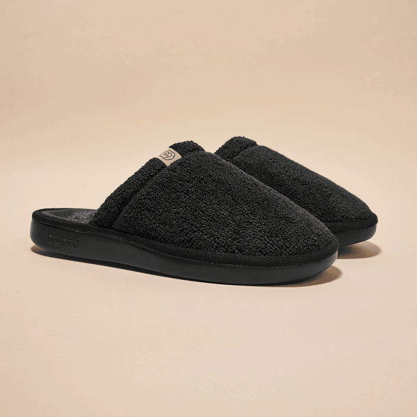 Angled view of Essential Spring slip-on shoe showing low-profile silhouette and rounded toe on white background