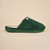 Side view of Essential Slipper showcasing forest green terry upper and cushioned branded sole on beige background