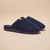 Front three-quarter view of navy Essential slipper showing plush terry upper and cushioned molded sole on beige background