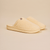Three-quarter view of Essential slipper showing cream sherpa upper, slip-on style, and cushioned sole with embossed Brunch logo on a neutral background
