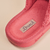 Close up of Essential slipper interior showing coral pink terry lining, stitched Brunch label and embossed Brunch logo on beige background