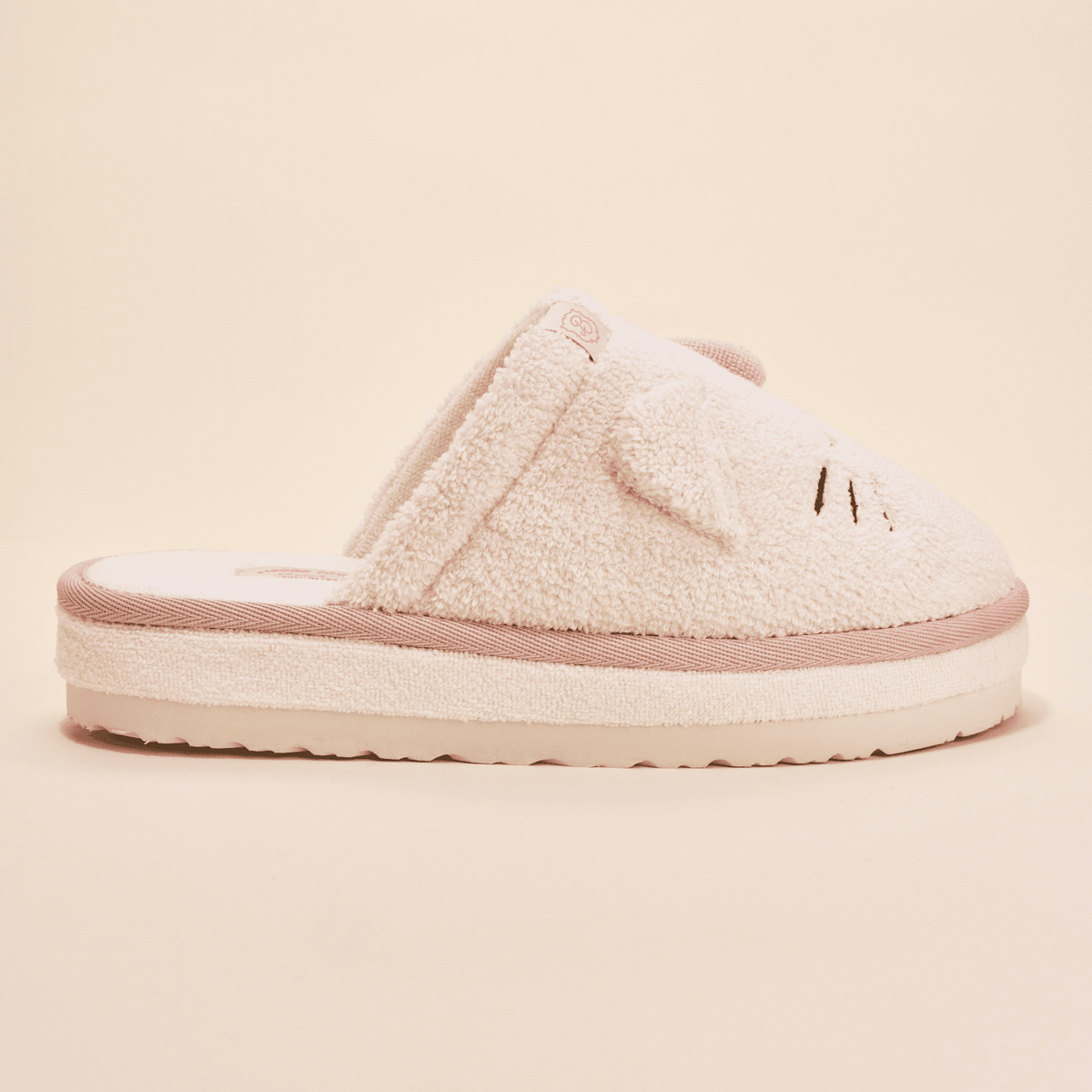 Side view of Hello Kitty Essential XXL slipper in cream terry with 3D ears, whisker embroidery, and thick platform sole