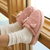 Side view of Essential XXL Hello Kitty slipper in pink terry showcasing 3D ears and bow with thick EVA sole on feet by window