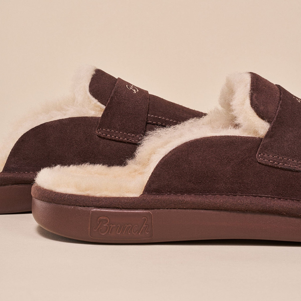 Close-up side view of Loafer Shearling in espresso brown suede showing cream shearling lining and Brunch logo on sole