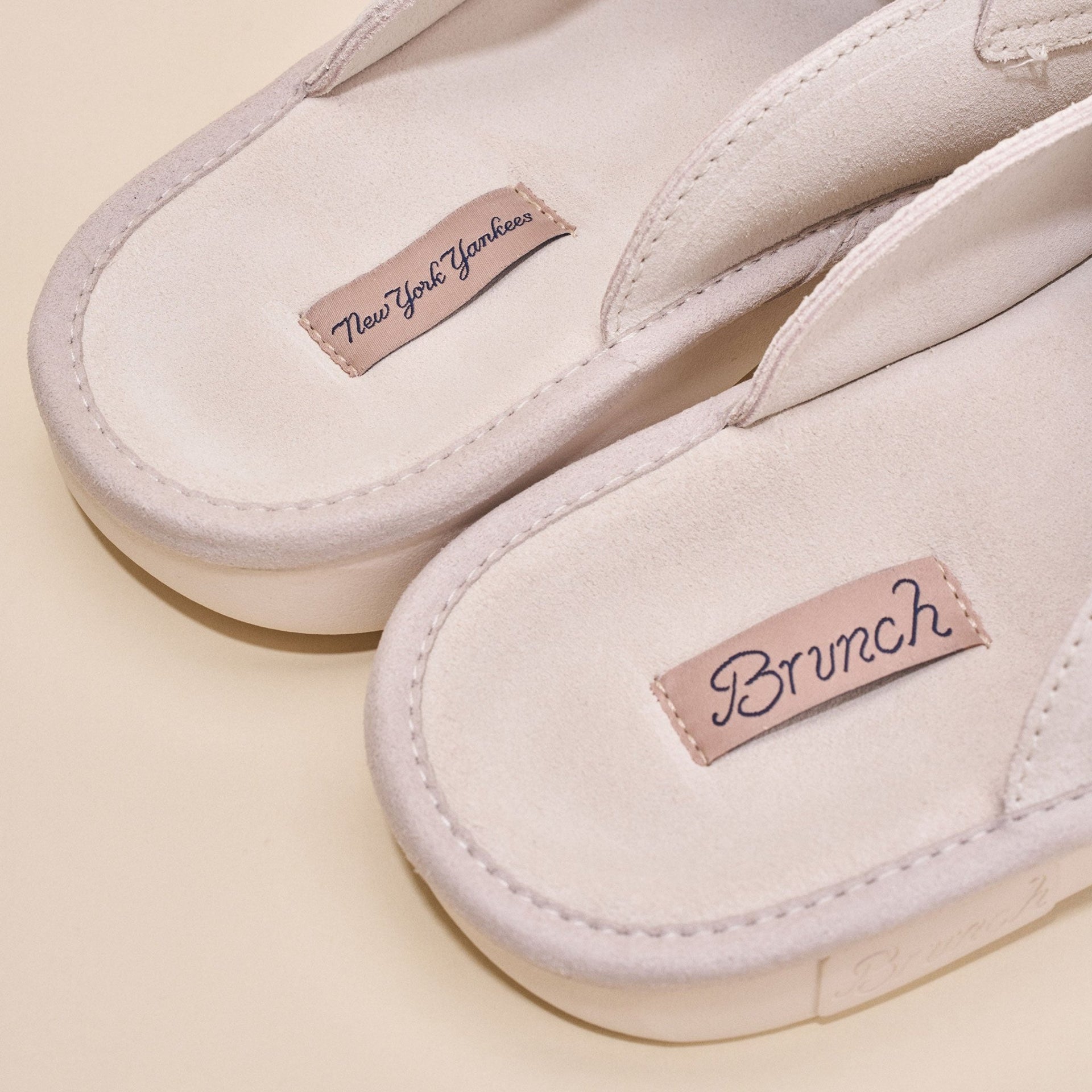 Close-up top view of cream suede Yankees loafer showing stitched upper and Brunch and New York Yankees insole labels