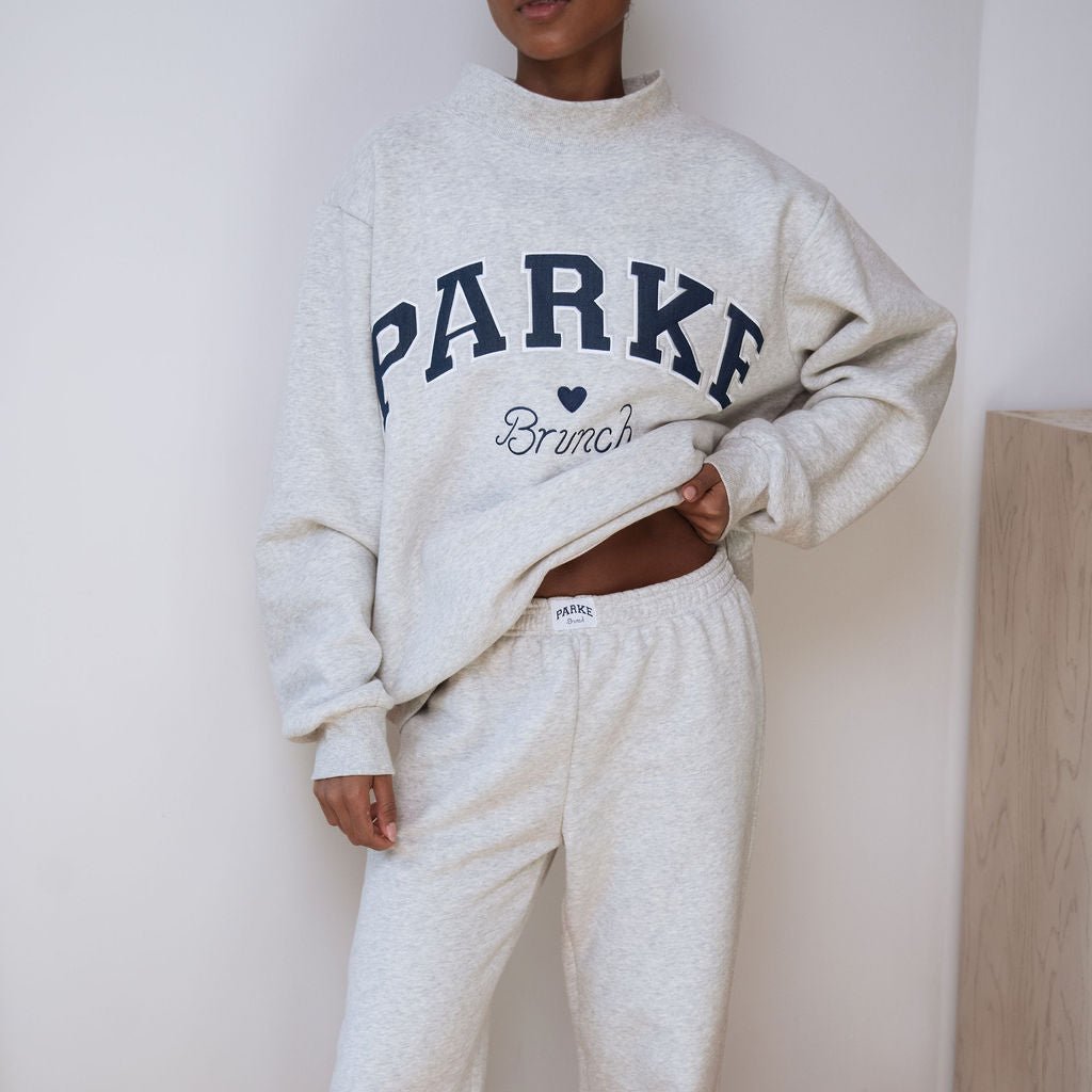 Front view of Parke mockneck sweatshirt and sweatpants showing oversized fit and PARKE logo on classic grey background