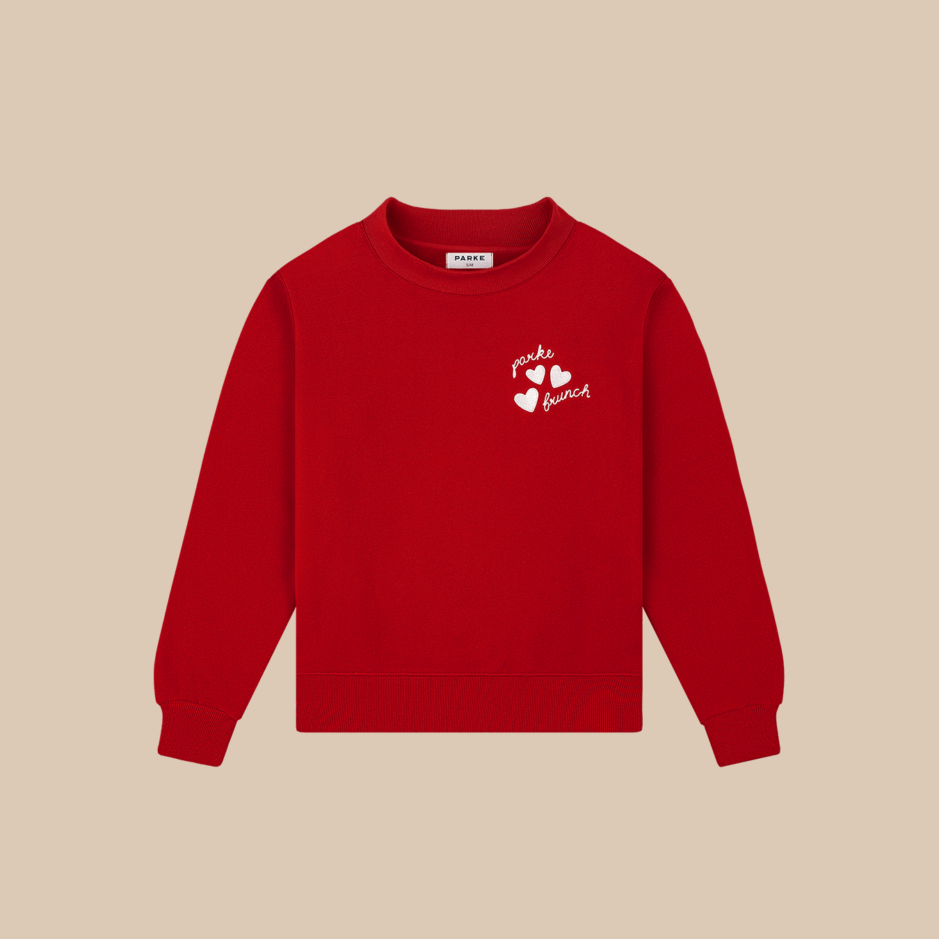 Front of Parke mockneck fleece sweatshirt in crimson with small white embroidered hearts and parke brunch logo on beige