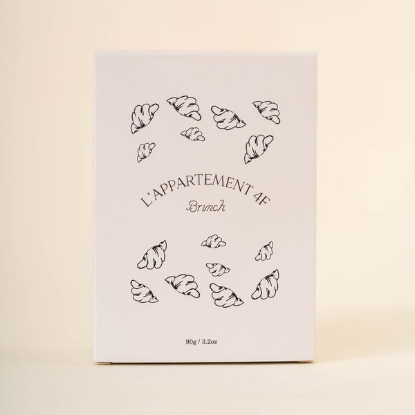 Front view of Petite Cereale au Nutella box with L'Appartement 4F Brunch logo, croissant illustrations, and 90g / 3.2oz on cream background