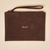 Top view of Brunch suede pouch in espresso brown showcasing embroidered Brunch logo, zip closure and wrist strap on a light beige background