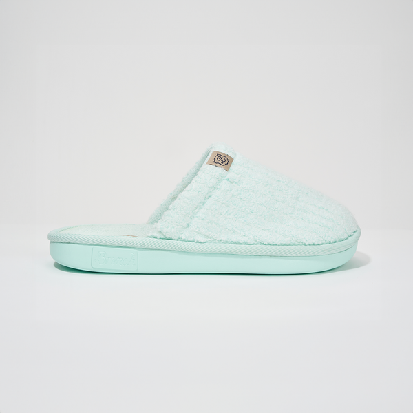 Side view of Lido Essential slipper showcasing ribbed terry upper and cushioned teal sole on white studio background
