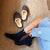 Top-down view of navy ribbed cashmere-wool socks on a model showing mid-calf fit and ribbed texture on a beige carpet
