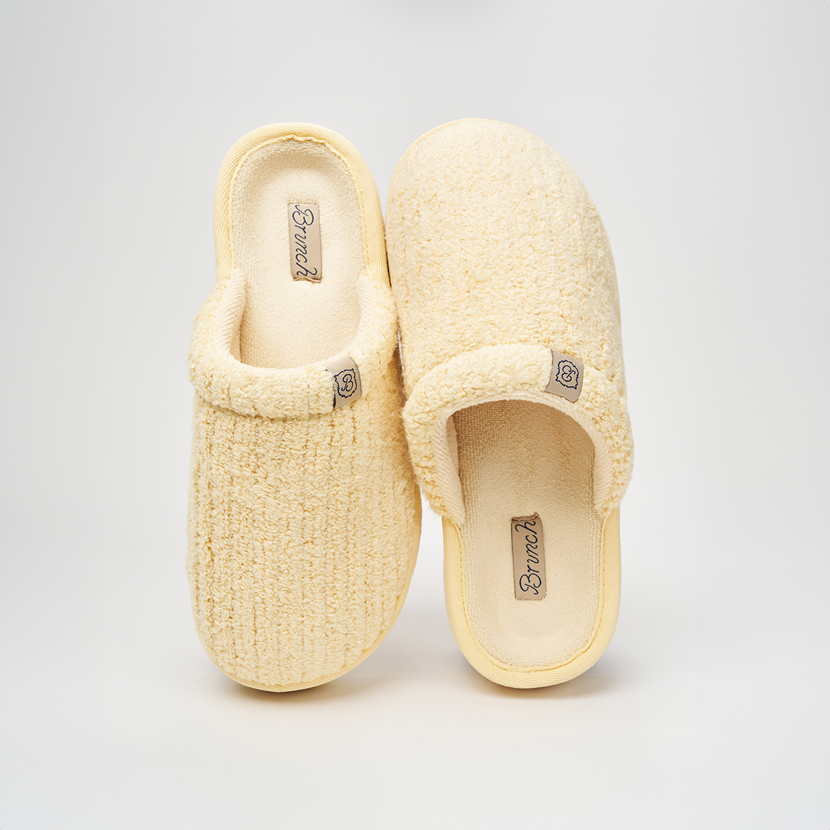 Top view of Essential XXL slippers in Limoncello ribbed terry showing plush texture and Brunch logo on light gray background
