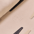 Close-up of Travel Backgammon Set interior showing beige suede texture, embossed Brunch logo, and stitched leather tabs