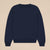 Back view of navy Varsity Crewneck in French terry showing ribbed neckline, cuffs, and hem on beige background