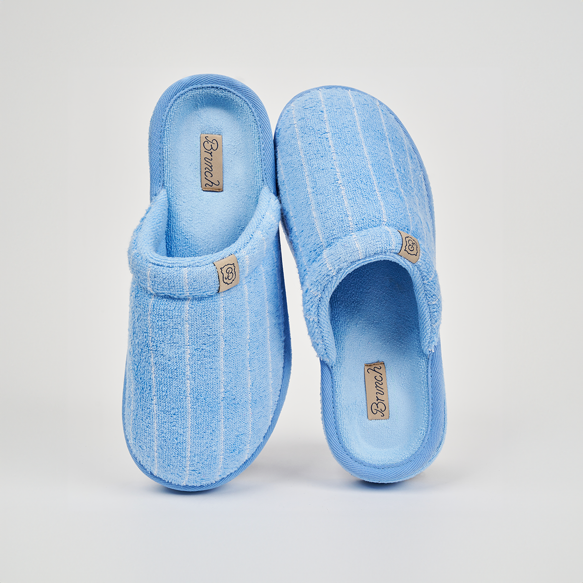 Angled top view of Essential Cabana terry slippers showcasing blue and white stripes and padded sole on a white background